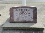 A granite memorial stone honoring SFC Tony W. Burris, located at Burris Field, with inscriptions detailing his service and dedication.