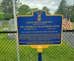 A blue and gold historical marker at Maple Grove Cemetery commemorating Pvt. Charles N. McClopper, detailing his military service and legacy.
