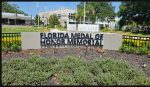 Sign for Florida Medal of Honor Memorial, displayed in a landscaped area.