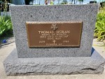 Memorial plaque dedicated to Thomas Horan, inscribed with his name, years of birth and death, and a cross symbol.